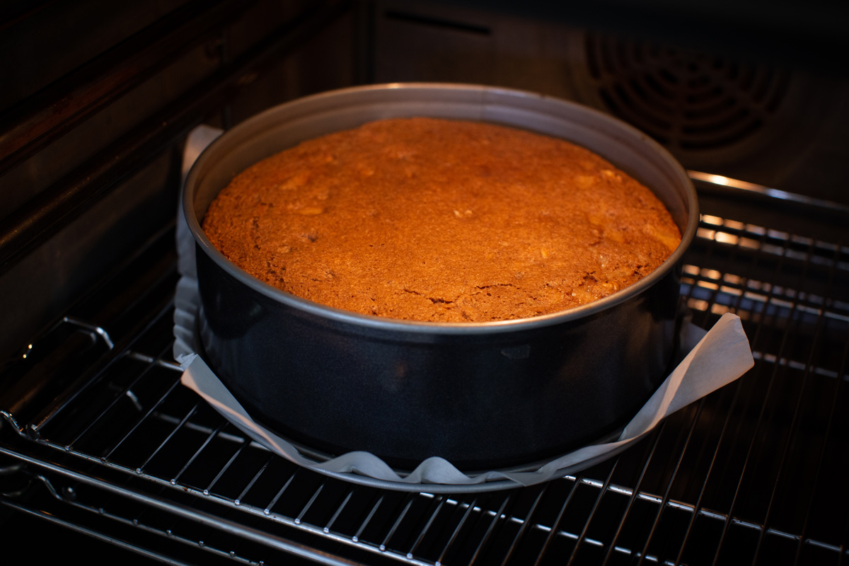 A view inside the oven, showing the feijoa cake rising in the cake pan.
