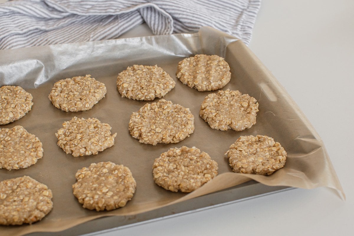 A tray full of raw ANZAC biscuits ready to go in the oven.